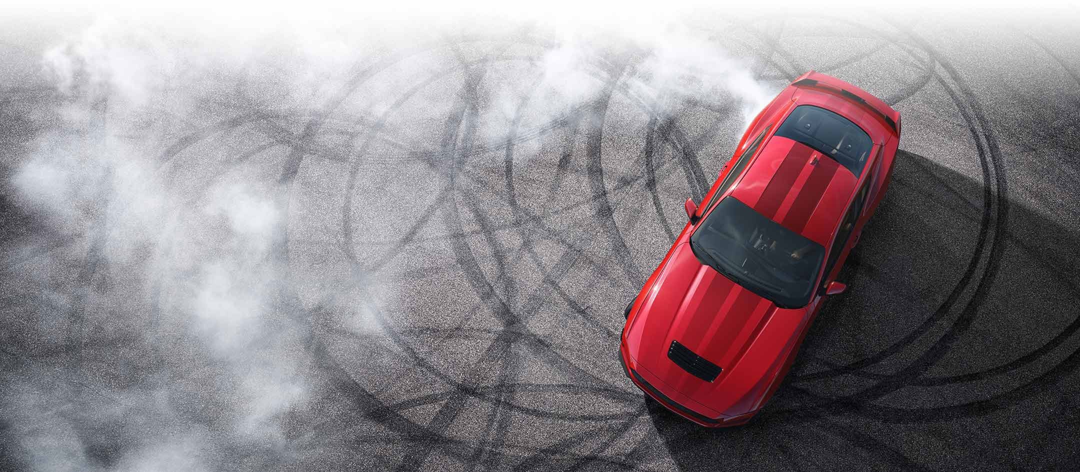 Overhead view of a 2024 Ford Mustang® model with tire tracks on pavement | Family Ford of Bluffton in Bluffton IN